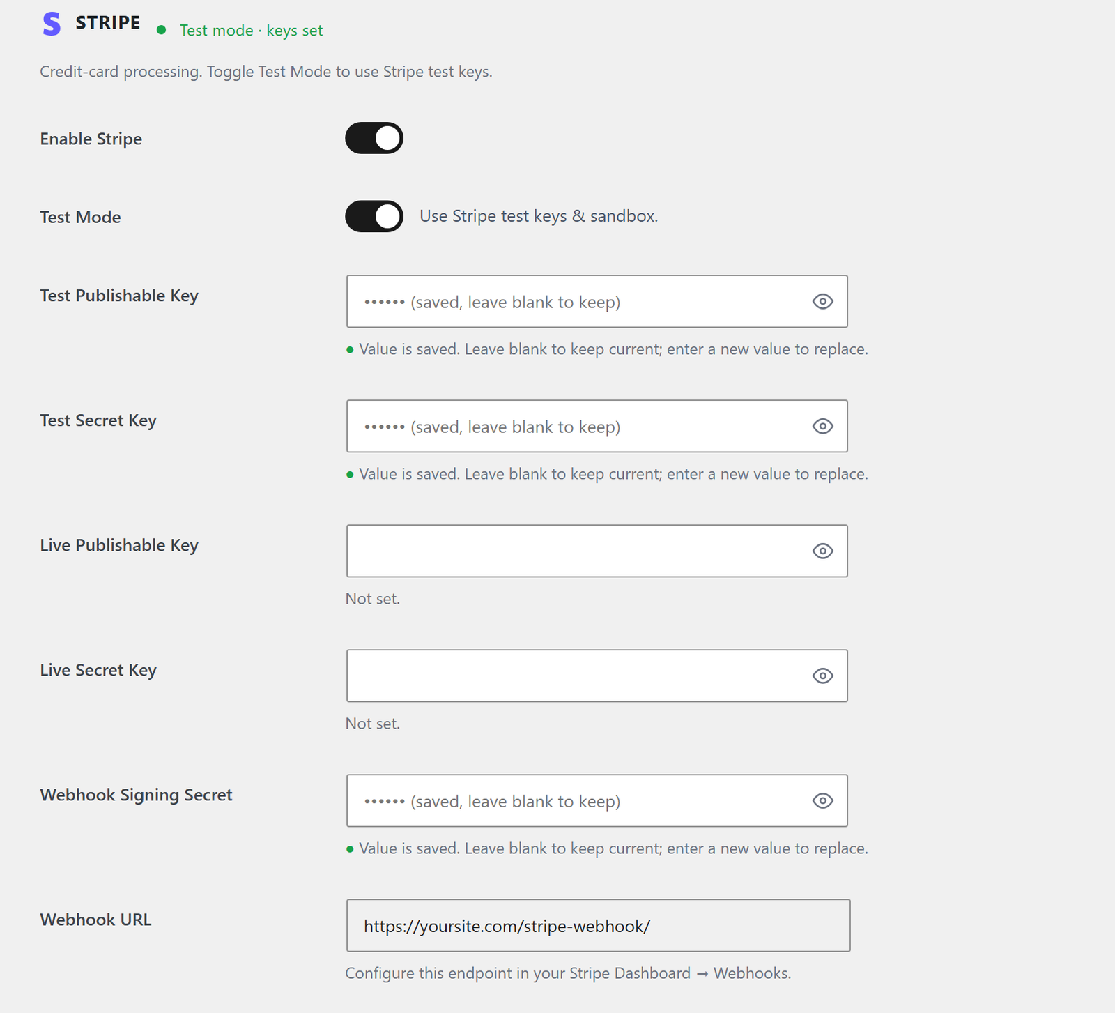 The Stripe card, showing the enable and test-mode switches, four key fields, the webhook signing secret and the webhook URL